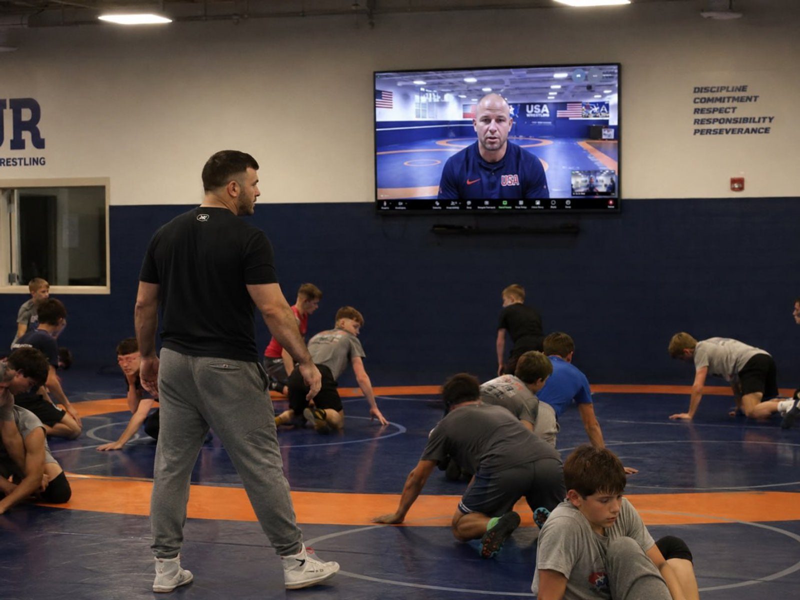 Athletes training live with a USA Wrestling national coach on screen